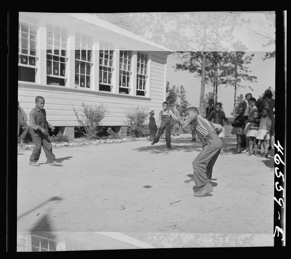 [Untitled photo, possibly related to: Boyd Jones playing dodge ball during recess at the Alexander Community School, Greene…