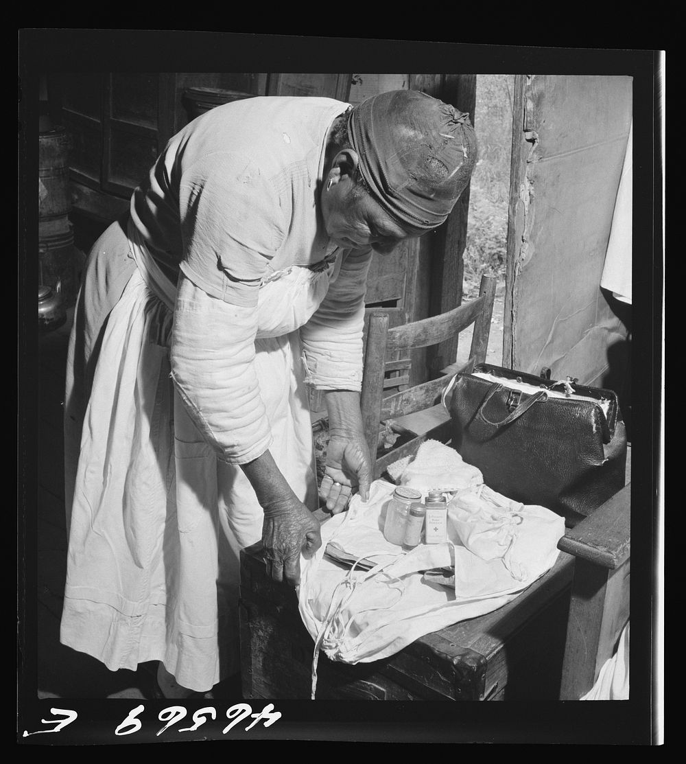 Midwife wrapping her kit to go on a call in Greene County, Georgia. Sourced from the Library of Congress.