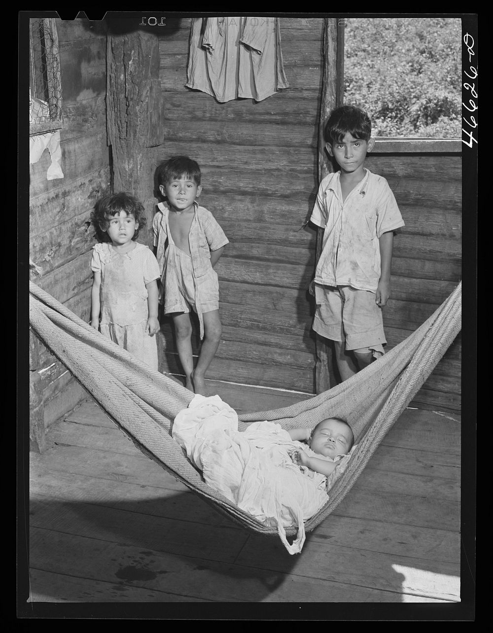 Manati, Puerto Rico (vicinity). Children of a farm laborer in their house which is on land FSA (Farm Security…