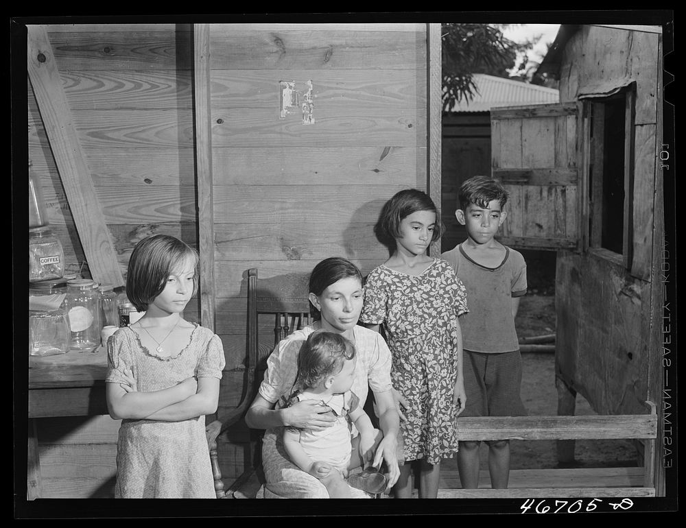 Bayamon, Puerto Rico (vicinity). Family living in an area which is to be taken by the Army. Sourced from the Library of…