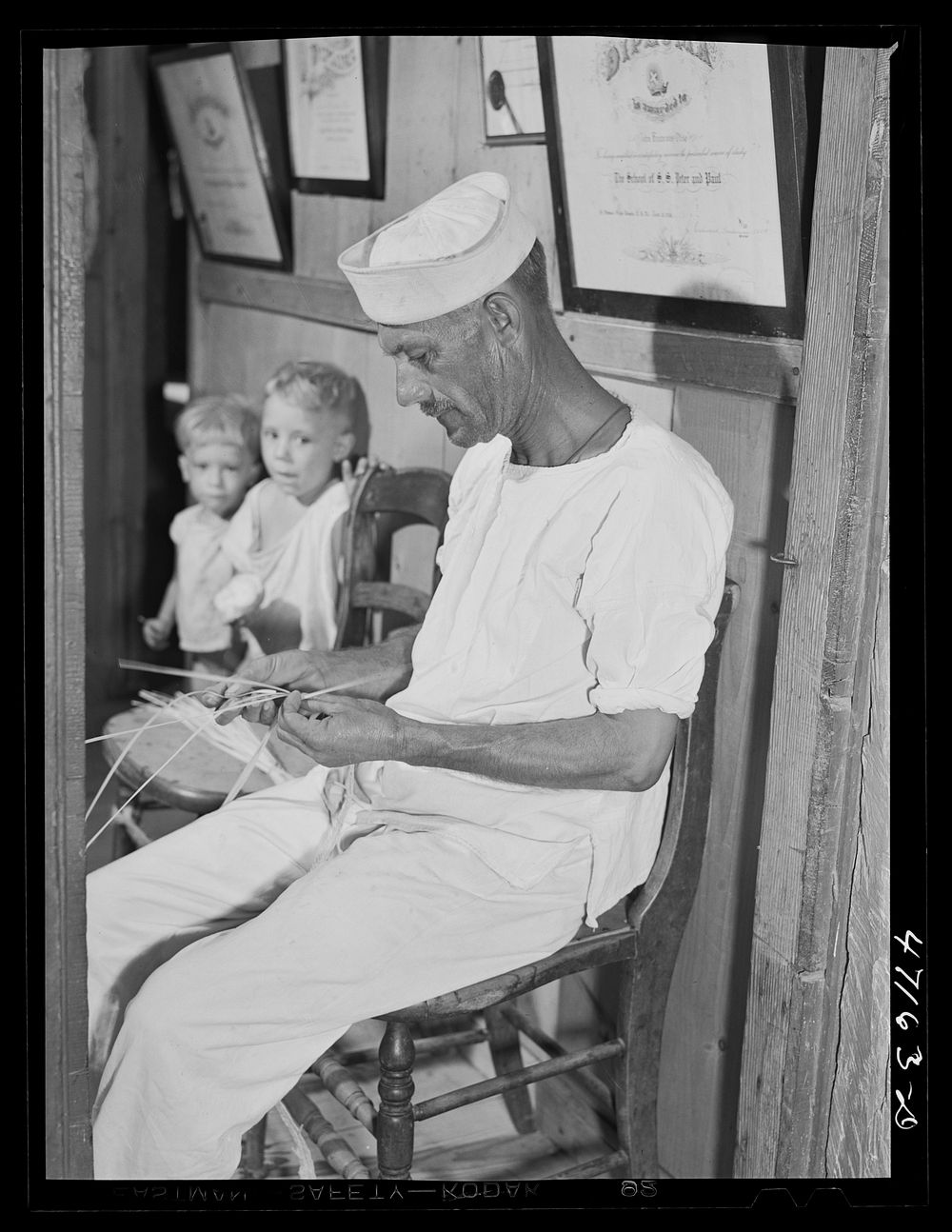 French village, a small settlement on Saint Thomas Island, Virgin Islands. A seaman who makes extra money weaving straw…