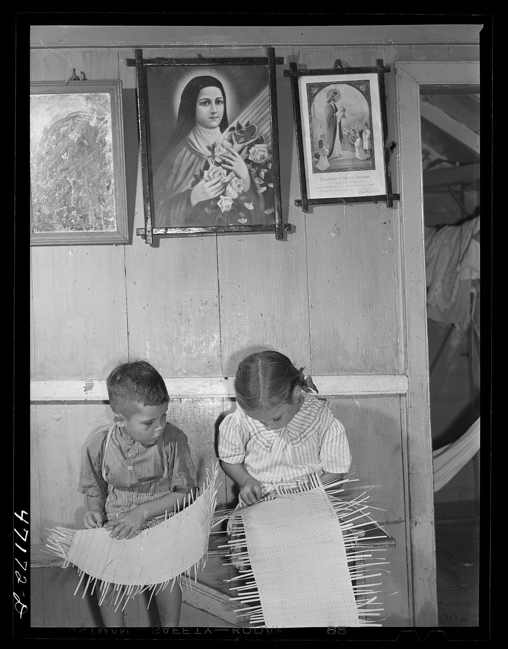 French village, a small settlement on Saint Thomas Island, Virgin Islands. French-speaking children weaving straw mats in…