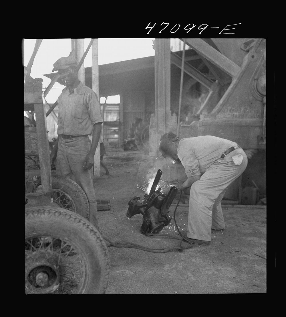 [Untitled photo, possibly related to: Saint Croix Island, Virgin Islands. Reconditioning machinery in the Bethlehem sugar…