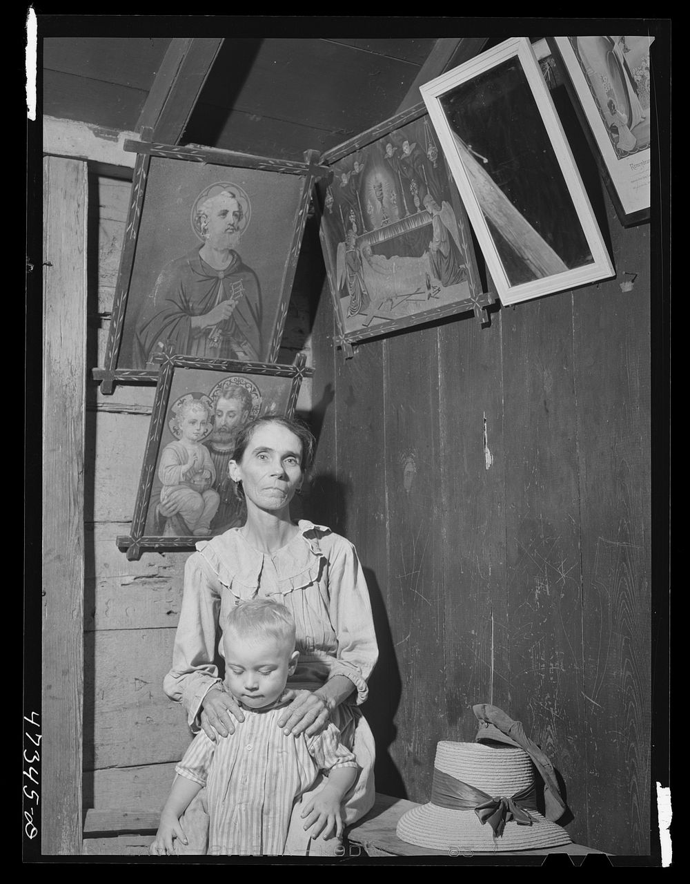 French village, a small settlement on Saint Thomas Island, Virgin Islands. French woman and one of her children in her home…