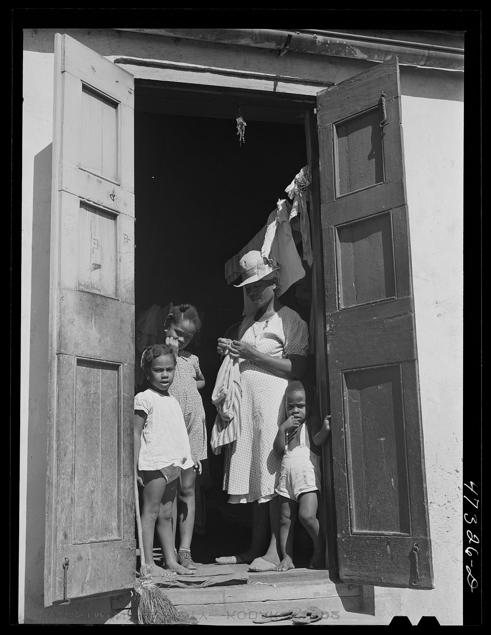 Charlotte Amalie, Saint Thomas Island, Virgin Islands. Family living in a slum section near the waterfront. Sourced from the…