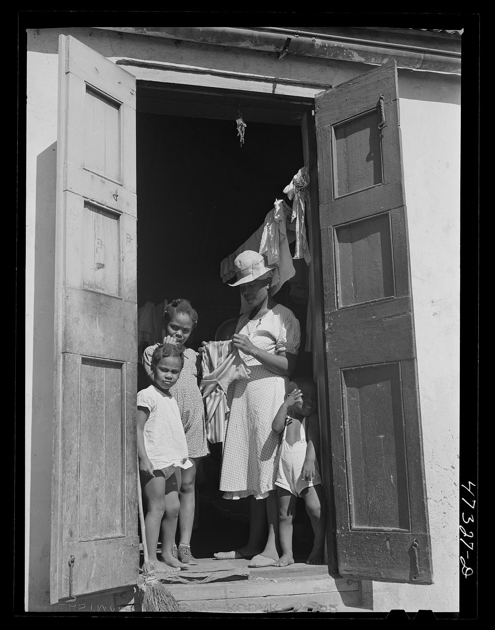 [Untitled photo, possibly related to: Charlotte Amalie, Saint Thomas Island, Virgin Islands. Family living in a slum section…