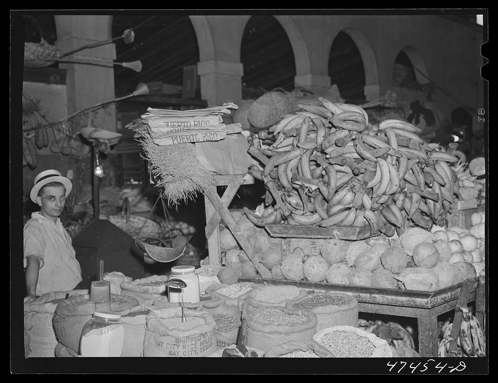 Rio Piedras, Puerto Rico. Bananas, coconuts, rice, beans and other produce for sale at the produce market. Sourced from the…