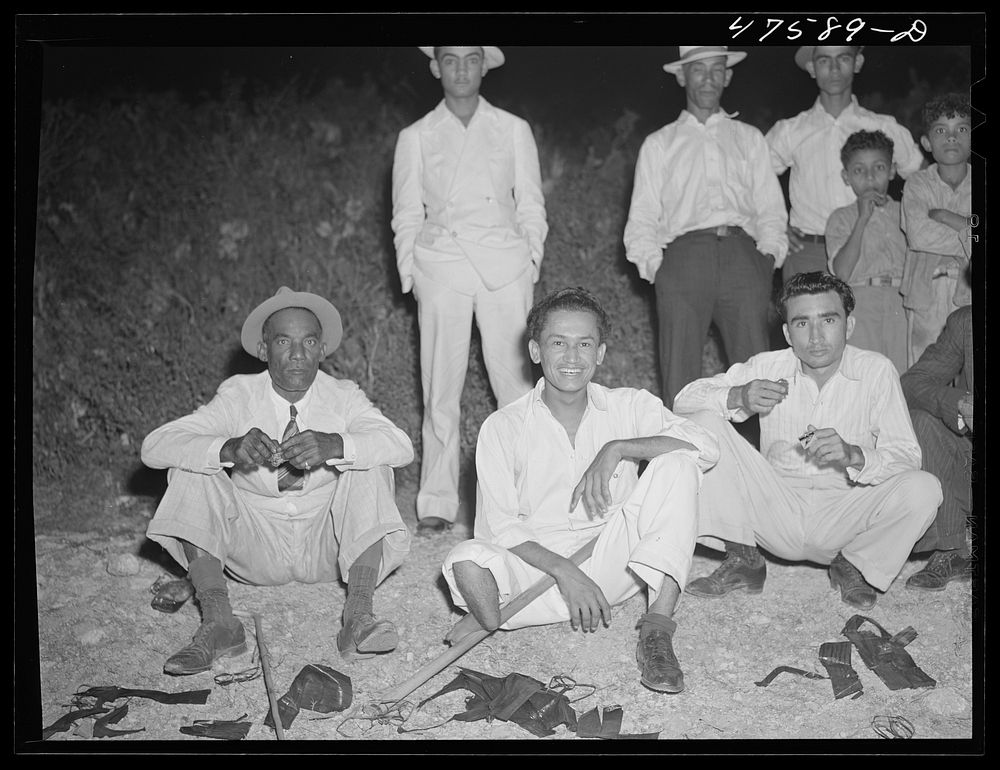 Guanica, Puerto Rico (vicinity). Eating "pastellas" at a Three Kings' eve party at the home of a farm laborer. Sourced from…