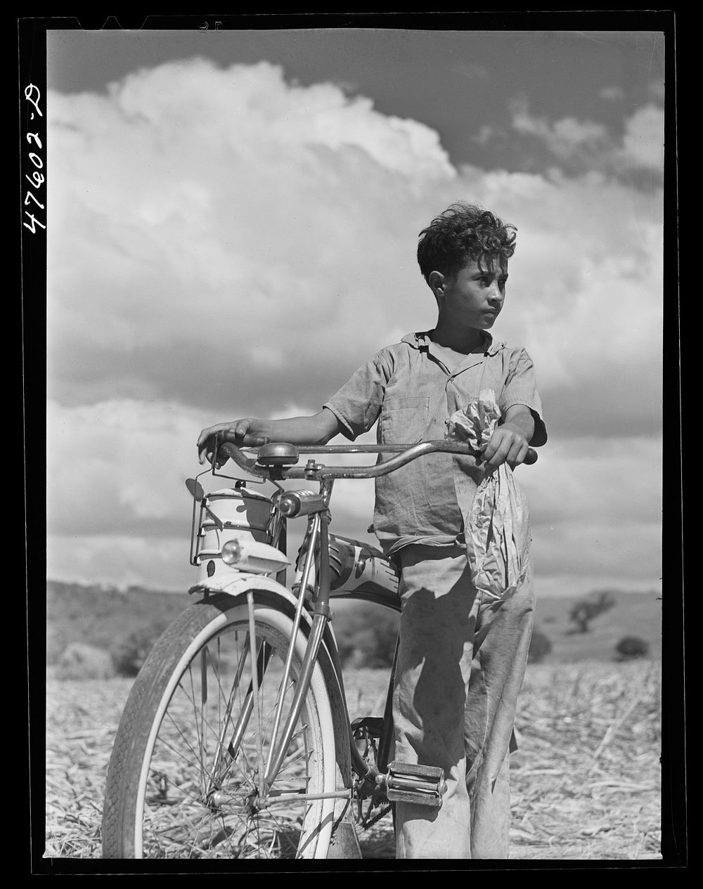 Guanica (vicinity), Puerto Rico. Young boy bringing lunch to his father who is working in the sugar cane fields. The lunch…