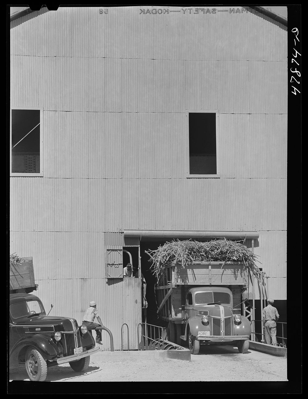 [Untitled photo, possibly related to: Ensenada, Puerto Rico. Apparatus for tilting the truck in order to slide the sugar…