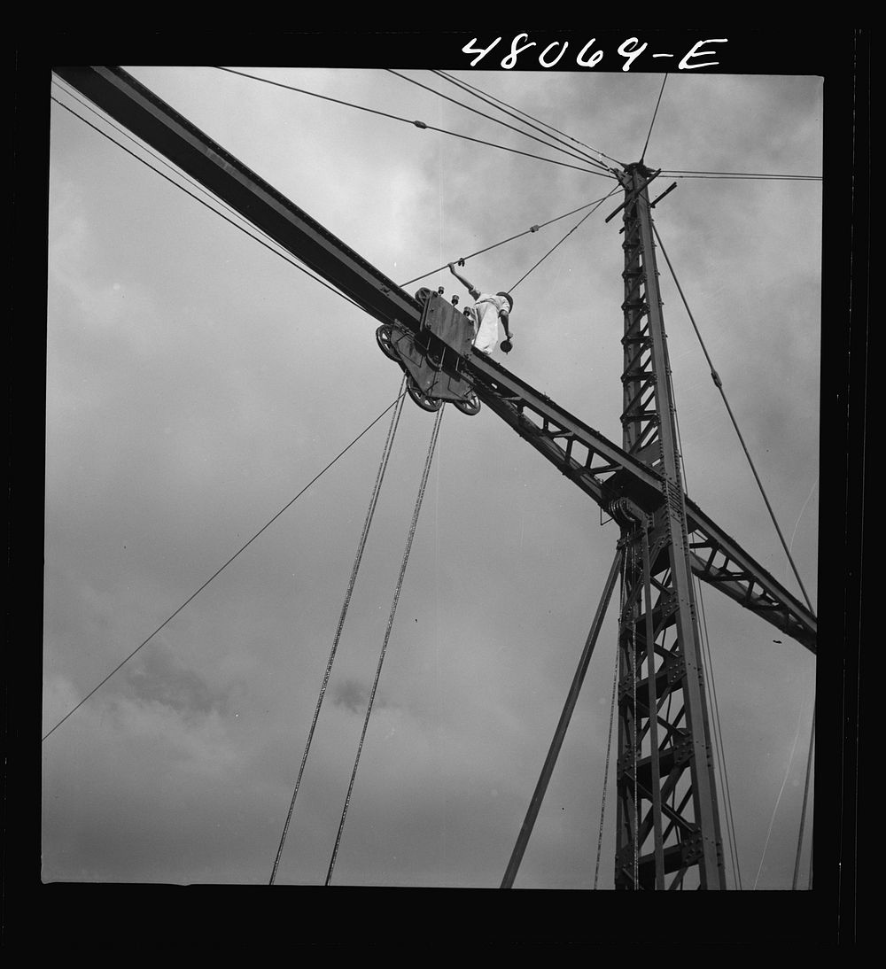[Untitled photo, possibly related to: San Sebastian, Puerto Rico (vicinity). Workman repairing a crane at a "central"].…