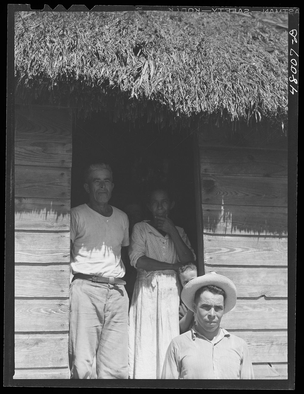 [Untitled photo, possibly related to: Arecibo, Puerto Rico (vicinity). Farm woman preparing bottles of coffee to be taken to…