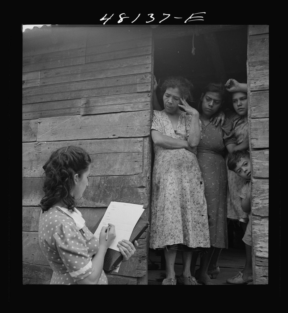 Utuado, Puerto Rico (vicinity). Farm laborer being interviewed by FSA (Farm Security Administration) home management…