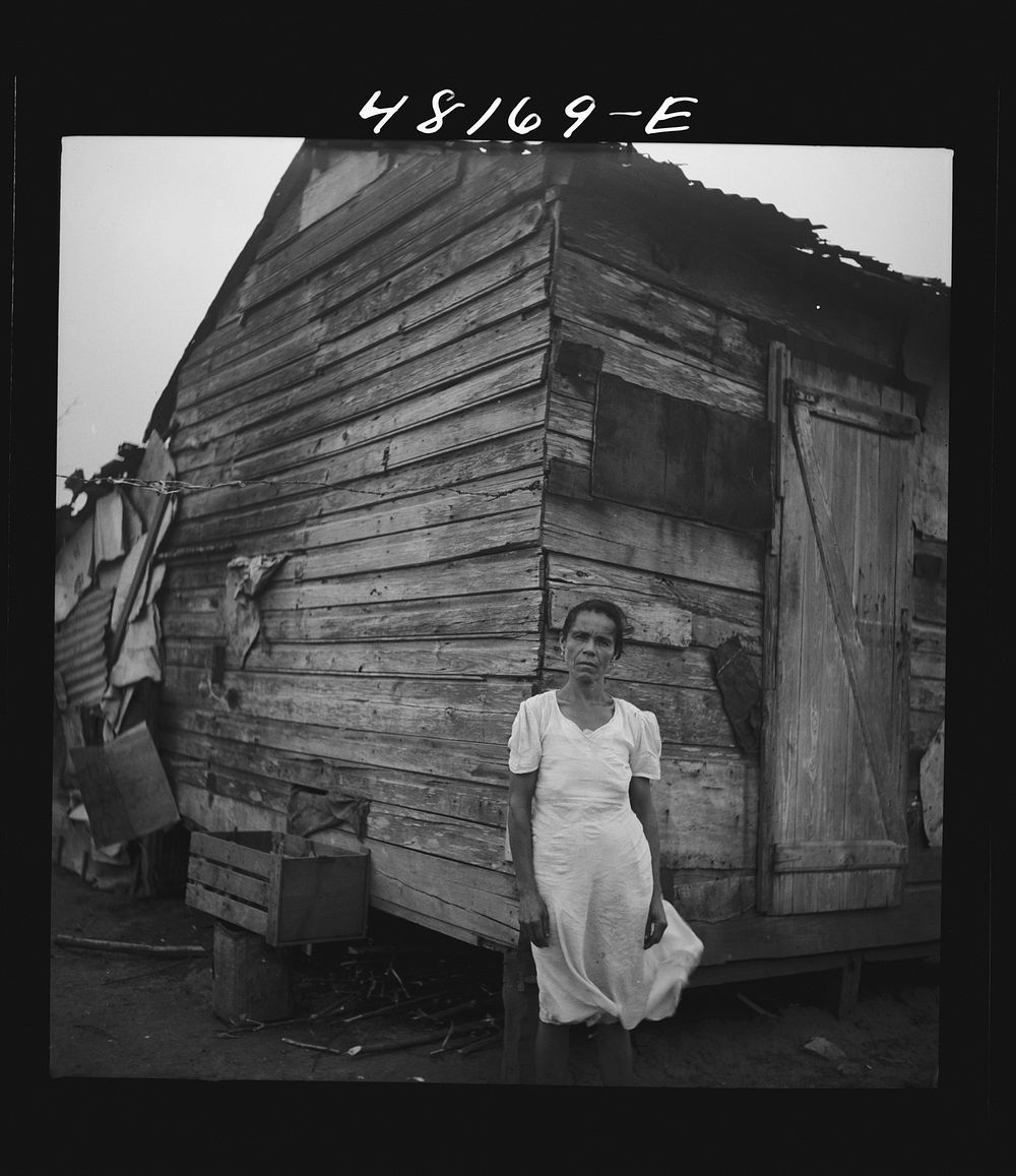 Santurce, Puerto Rico (vicinity). Woman who lives in a house on the land which FSA (Farm Security Administration) is buying…