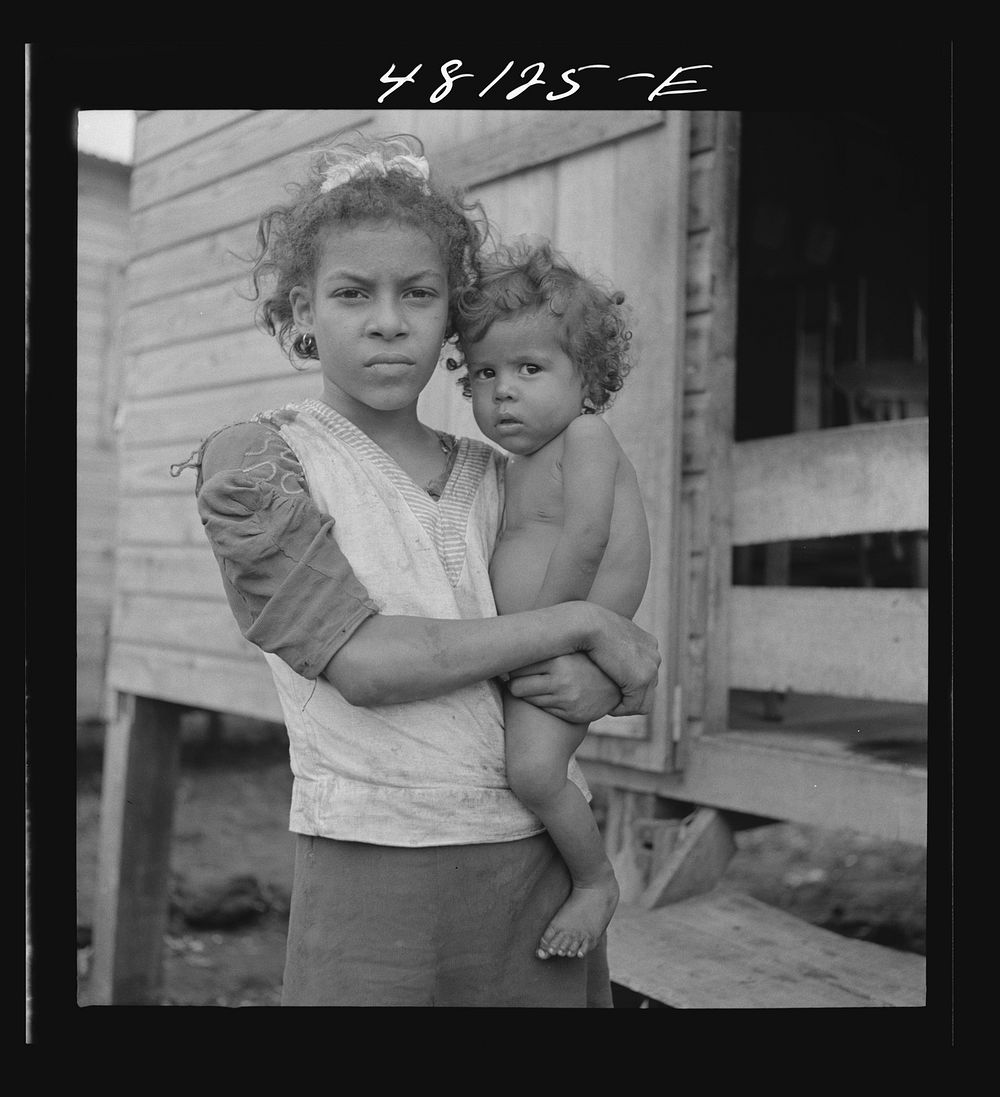 In the huge slum known as "El Fangitto." San Juan, Puerto Rico. Sourced from the Library of Congress.
