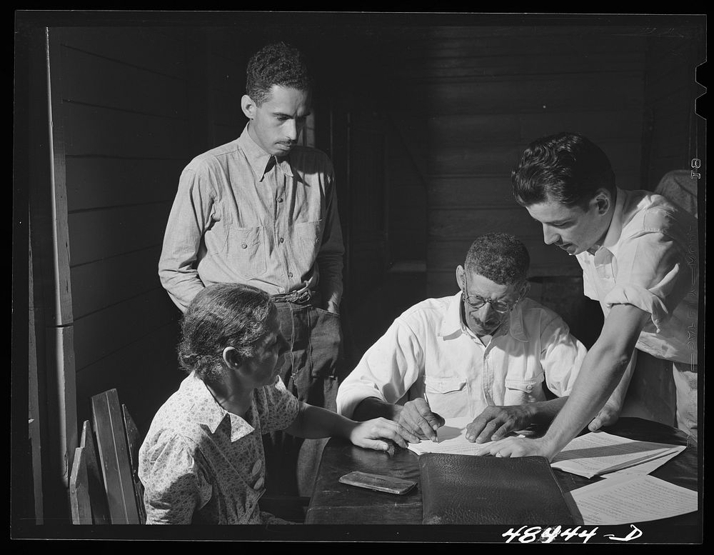 Aibonito (vicinity), Puerto Rico. FSA (Farm Security Administration) borrower and his family signing up for another loan.…