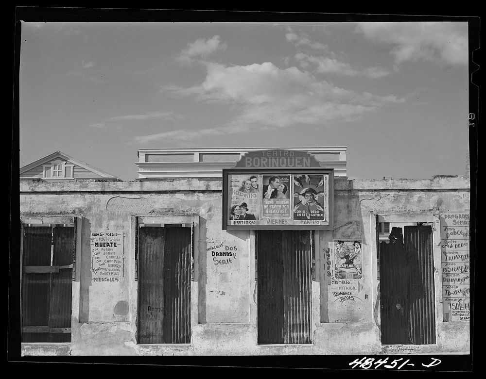 [Untitled photo, possibly related to: San Sebastian, Puerto Rico. Advertisements for movies on an old building]. Sourced…