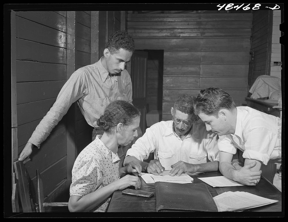 Aibonito (vicinity), Puerto Rico. FSA (Farm Security Administration) borrower and his family signing up for another loan.…