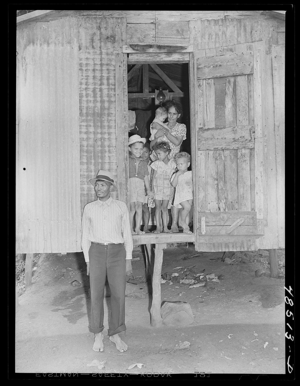 [Untitled photo, possibly related to: Yabucoa, Puerto Rico. Striking sugar cane worker and his family]. Sourced from the…