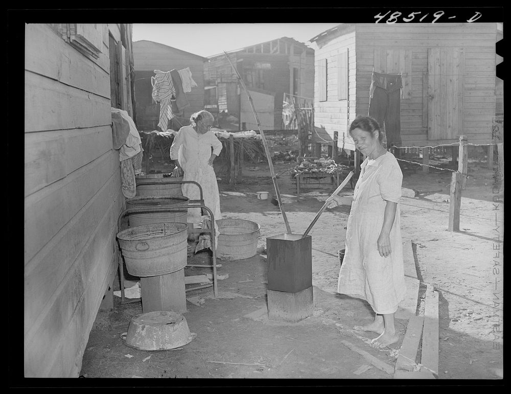 [Untitled photo, possibly related to: San Juan, Puerto Rico. Washing clothes in a back yard in El Fangitto, a slum area].…