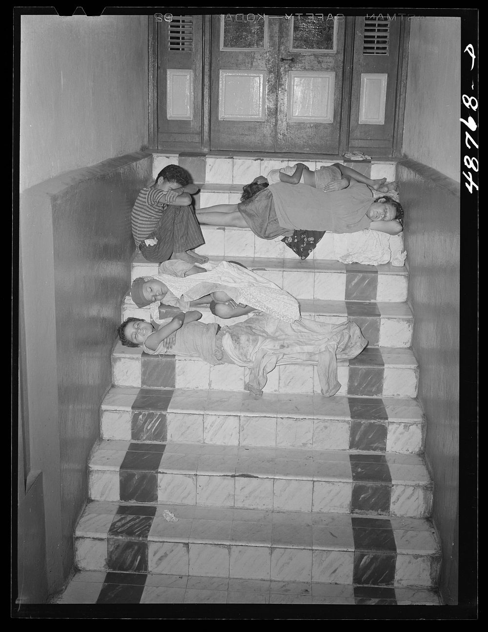 Caguas, Puerto Rico. Homeless people sleeping in the hallway of an apartment house. Sourced from the Library of Congress.