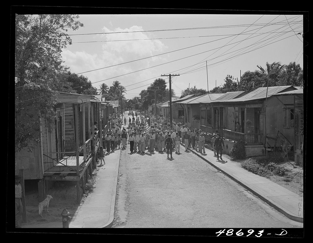 Yabucoa, Puerto Rico (vicinity). Procession of sugar strikers through a small town. Sourced from the Library of Congress.