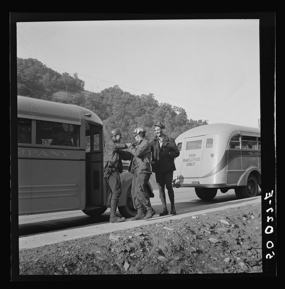Coal miners waiting along road for bus to take them home. In Welch, Bluefield section, West Virginia. Sourced from the…