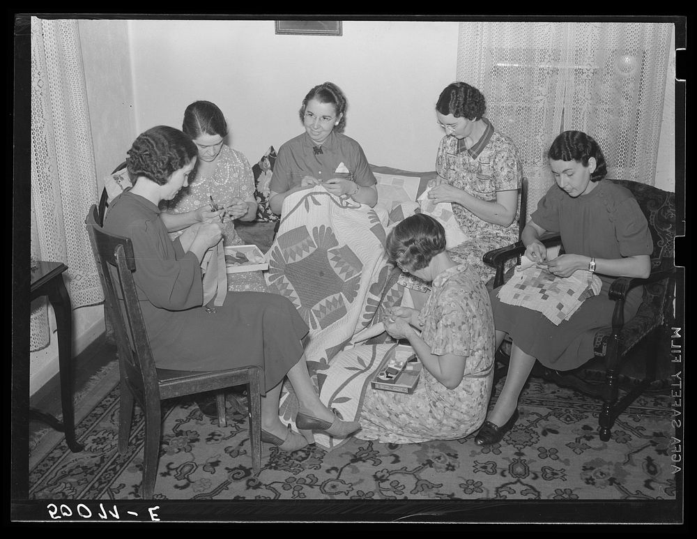 Housewives in Tygart Valley, West Virginia, have weekly group meetings in home economics. Here they are quilting. Sourced…