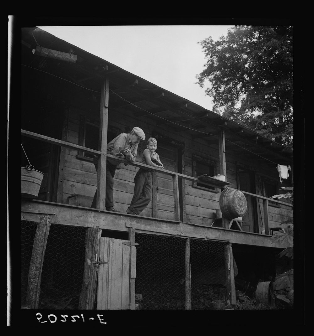 Coal miner and son on porch of their home. The "Patch,"  Cassville, West Virginia. Sourced from the Library of Congress.