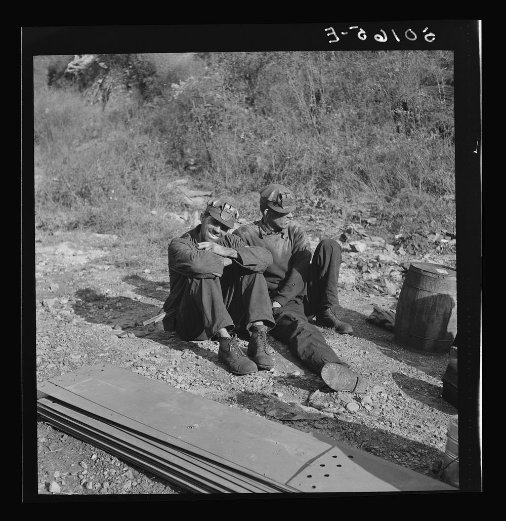 [Untitled photo, possibly related to: Coal miners waiting along road for bus to take them home. In Welch, Bluefield section…