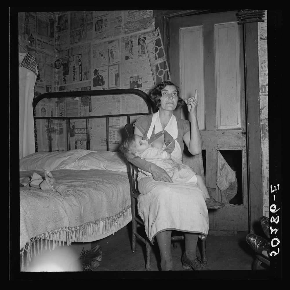 Coal miner's wife and child while discussing conditions of house, lack of steady work for husband. Bertha Hill, West…