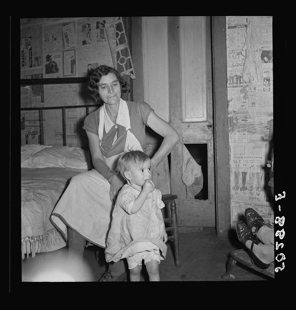 [Untitled photo, possibly related to: Coal miner's wife and child while discussing conditions of house, lack of steady work…