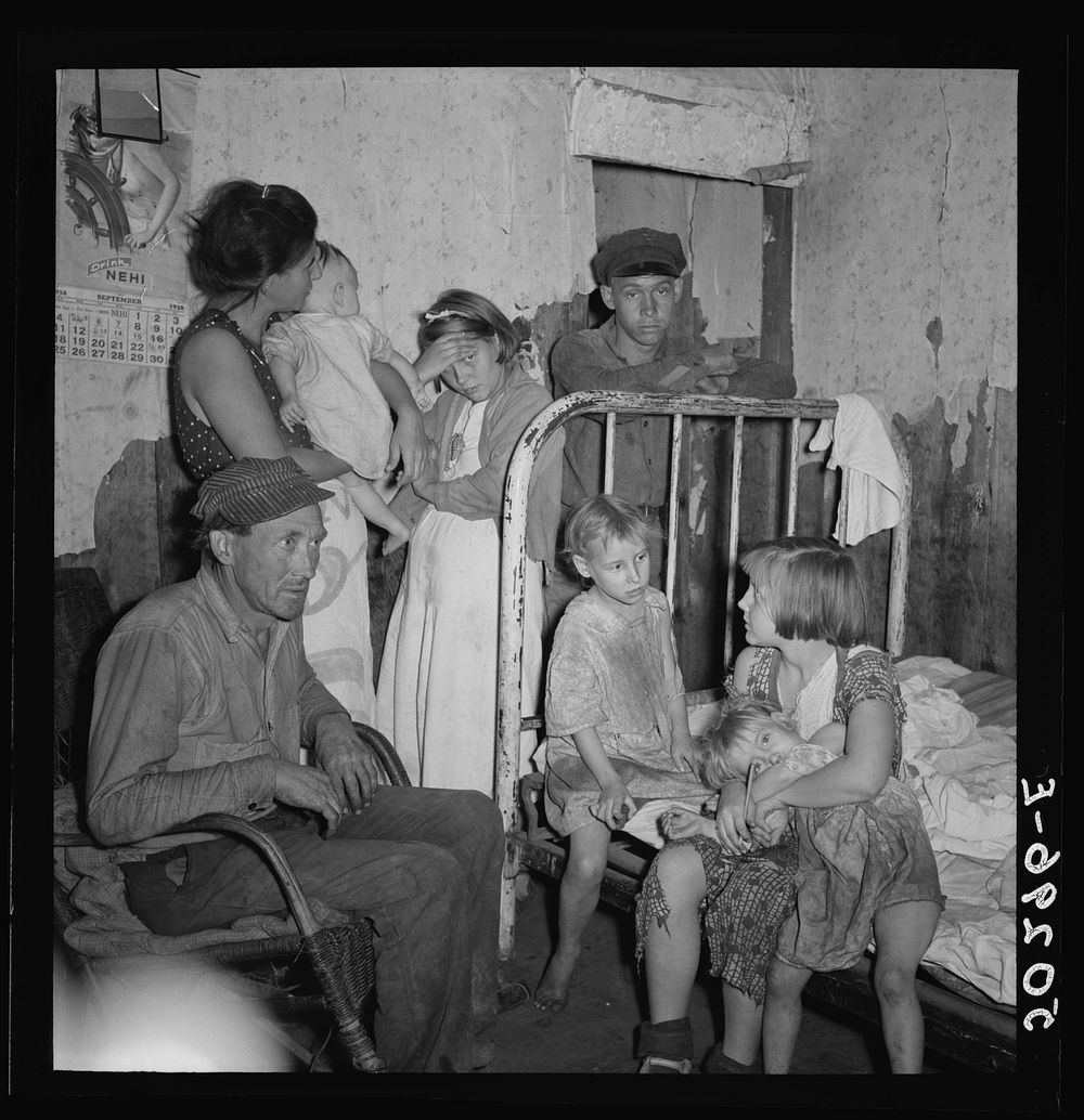 [Untitled photo, possibly related to: Coal miner and wife and children. He has been injured in mines four times. Since last…