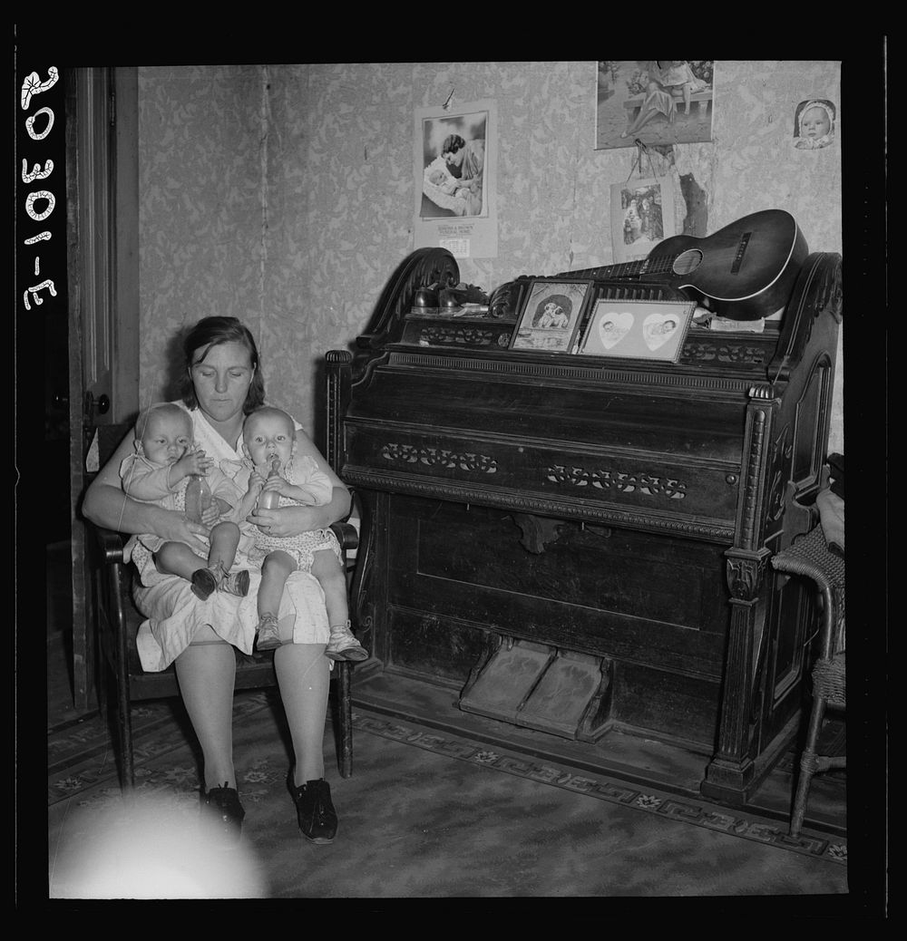 Coal miner's wife and youngest twins in family of ten. Pursglove, Scotts Run, West Virginia. Sourced from the Library of…