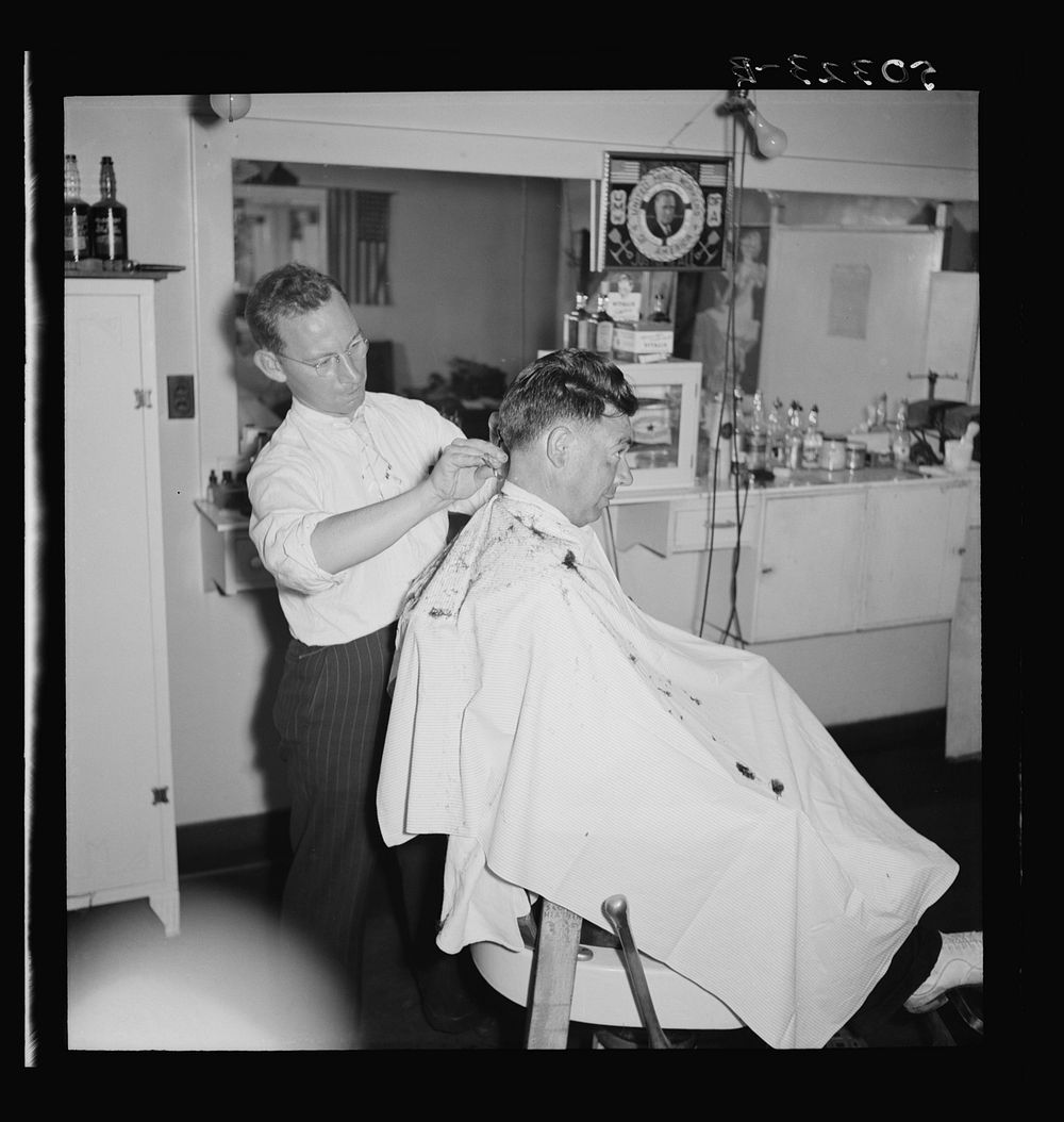 The barber is also the Justice of Peace in mining town of Osage, West Virginia. Sourced from the Library of Congress.