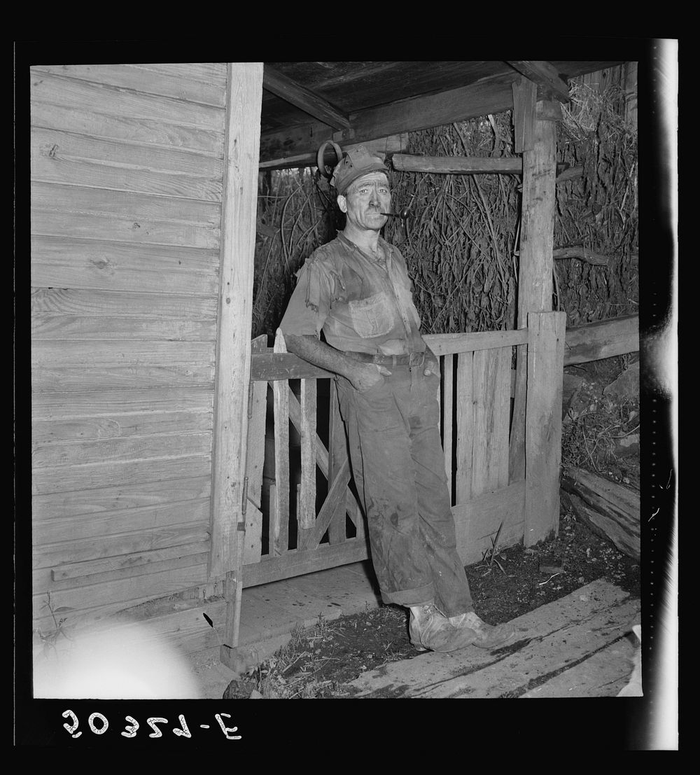 [Untitled photo, possibly related to: Coal miner (Italian) resting and smoking his pipe after coming home from work. "The…