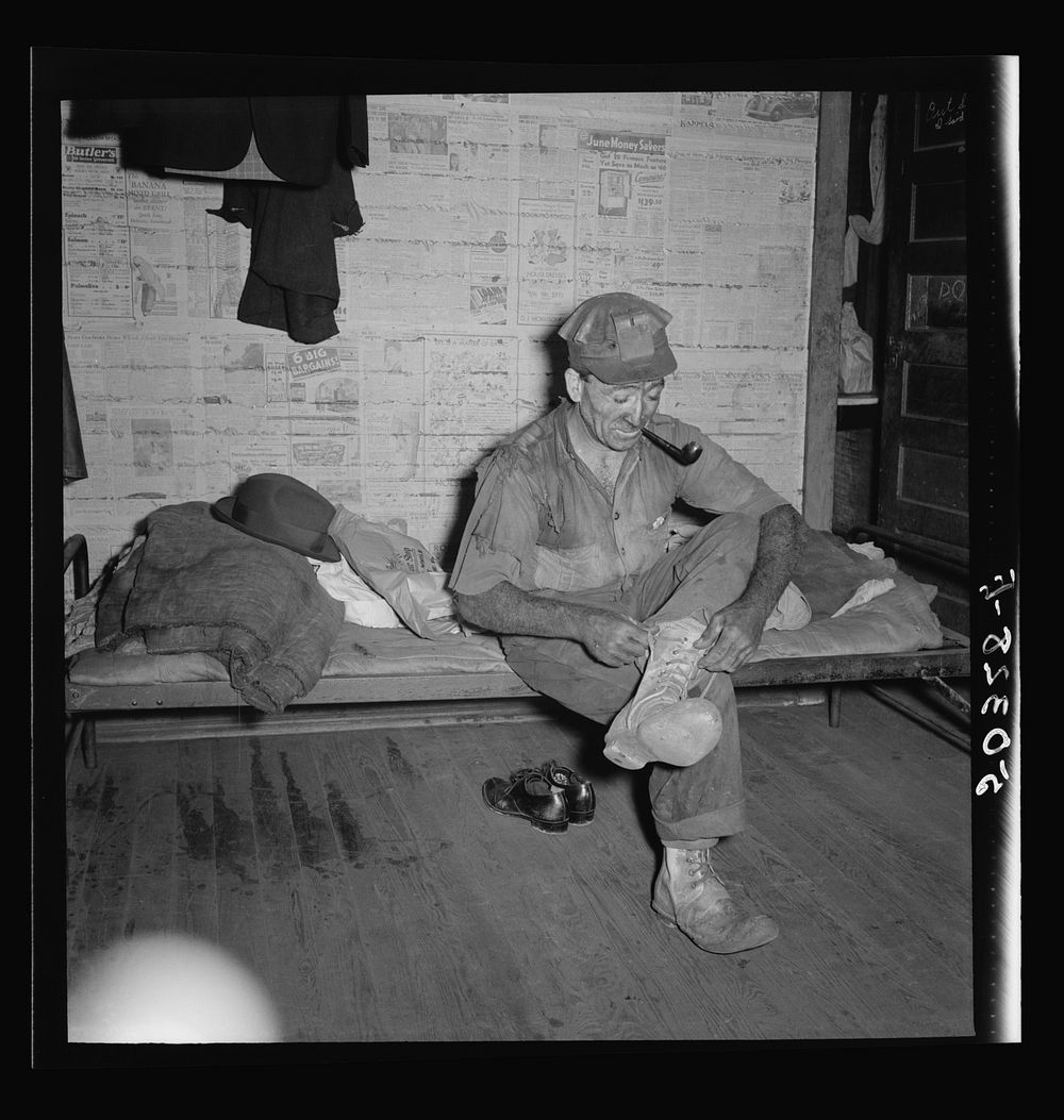 Coal miner (Italian) resting and smoking his pipe after coming home from work. "The Patch," Chaplin, West Virginia. Sourced…