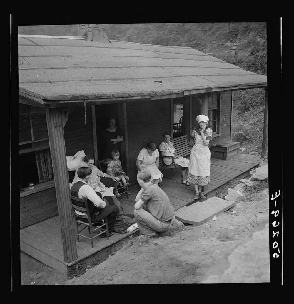 Family of man dying of T.B. gather around on front porch. Abandoned mining town, Marine, West Virginia. Sourced from the…