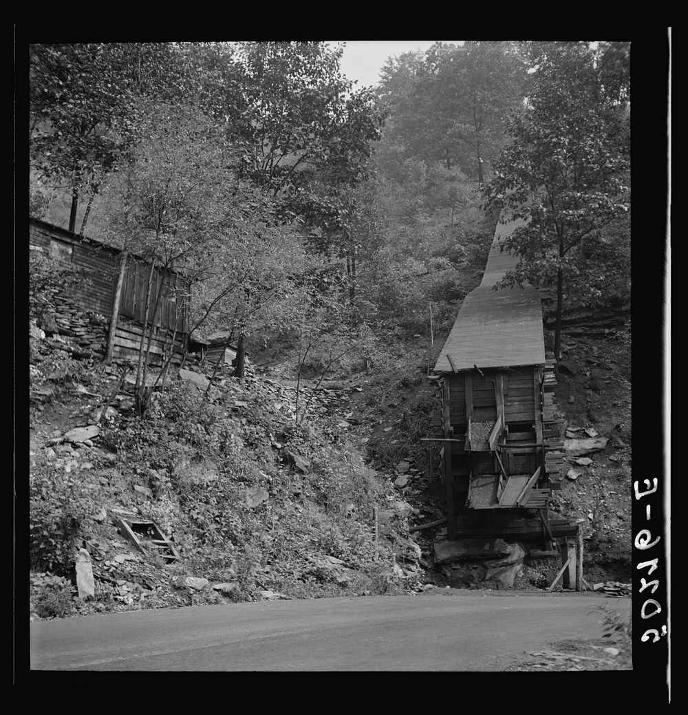 Small, privately owned coal mine next to owner's shacks by the side of the road. Mohegan, West Virginia. Sourced from the…