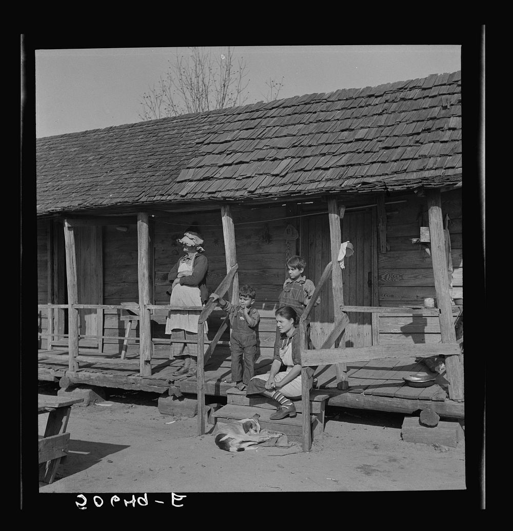 Indian (mixed breed) family on their front porch near Pembroke Farms. Maxton, North Carolina. Sourced from the Library of…