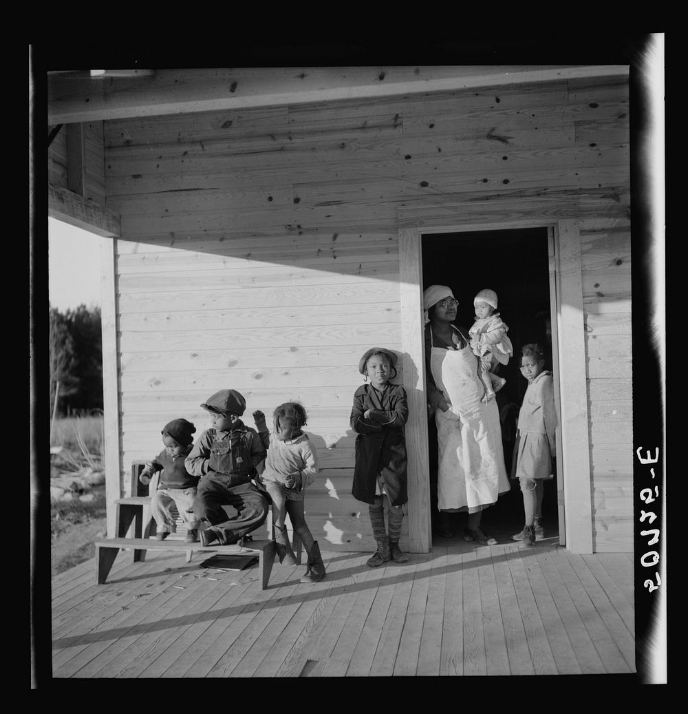Family of rehabilitation client on front porch of new home near Raleigh, North Carolina. Sourced from the Library of…