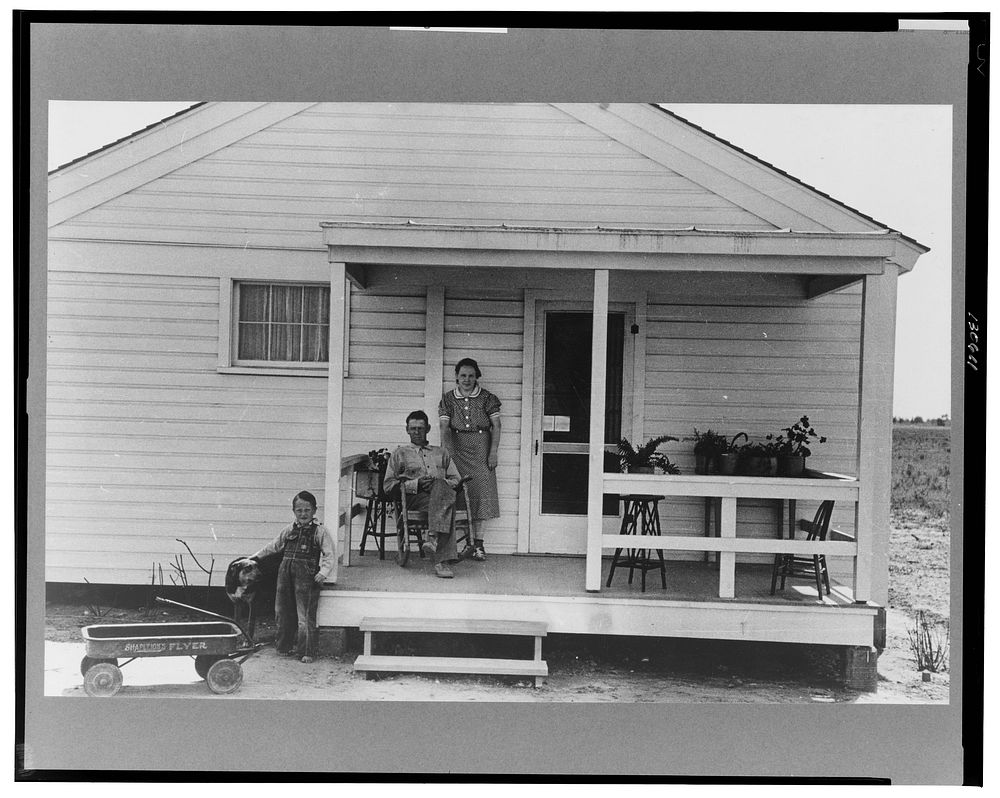 Southeast Missouri Farms. Family of FSA (Farm Security Administration) client, former tenant farmer, on front porch of new…