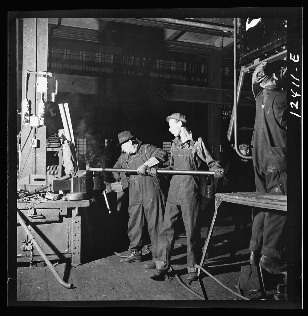 Chicago, Illinois. Workers bending a pipe for the repair of a locomotive at the Chicago and Northwestern Railroad shops.…