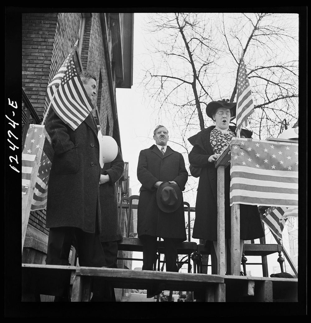 Chicago (north), Illinois. Alice Burns, who sings on a local radio station, leading the singing of the national anthem at a…