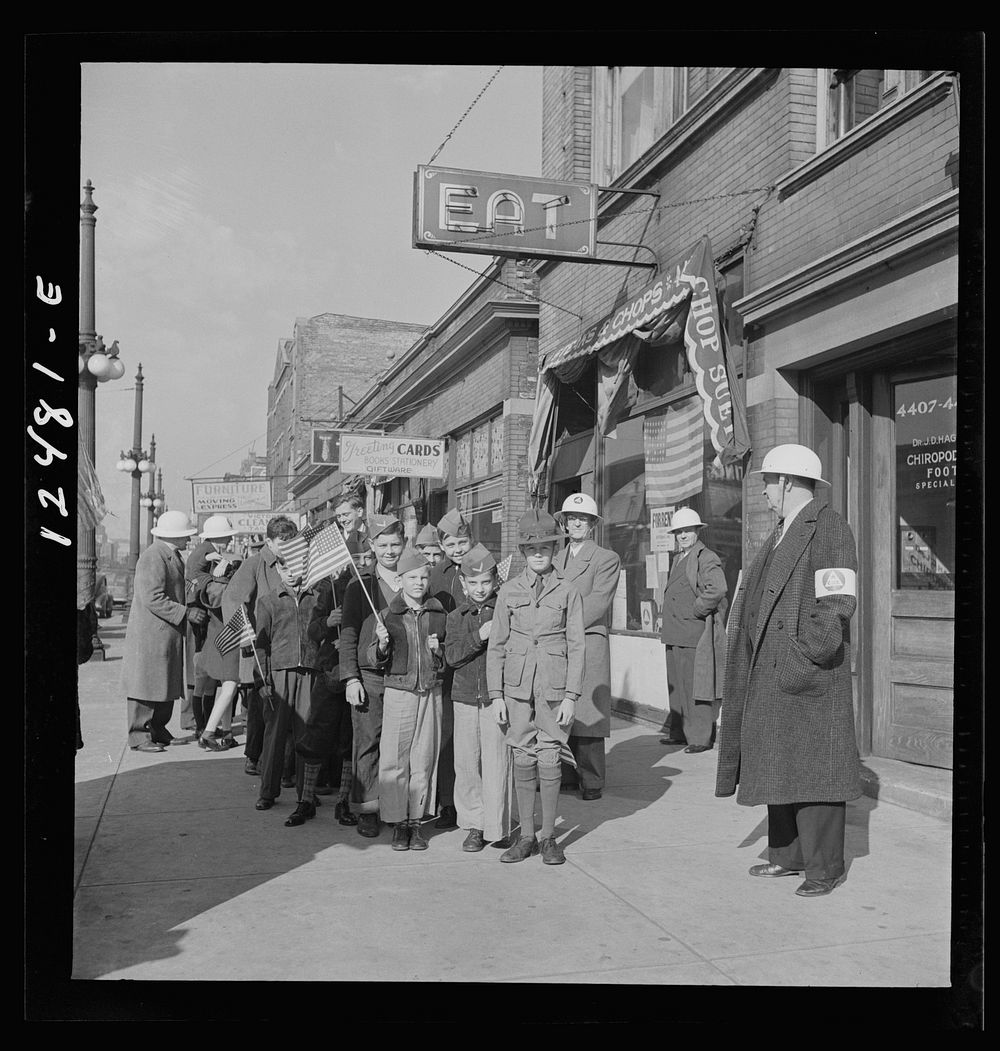 Chicago (north), Illinois. Parade, starting at Office of Civilian Defense headquarters, before the dedication of a flag in…