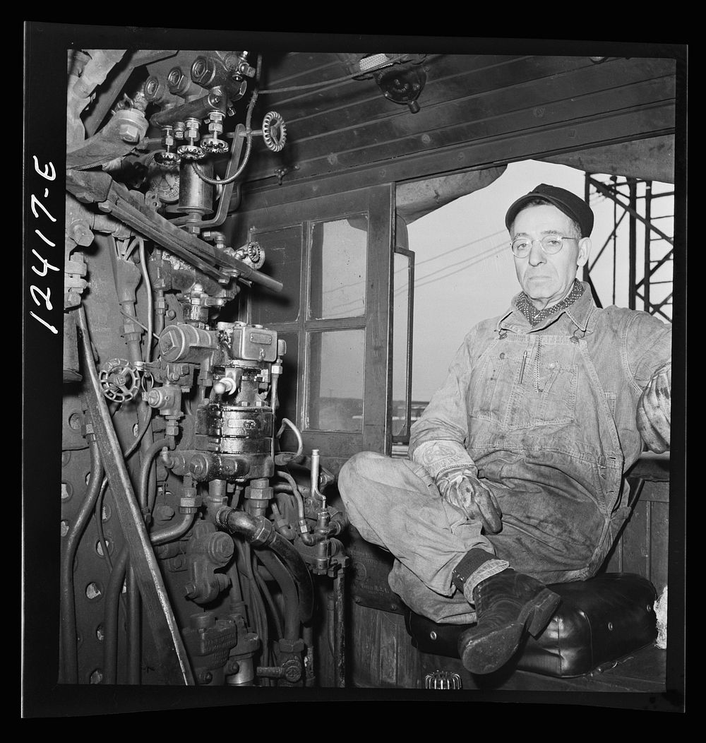 Chicago, Illinois. Engineer of a locomotive waiting to make his run to Clinton, Iowa from a Chicago and Northwestern…