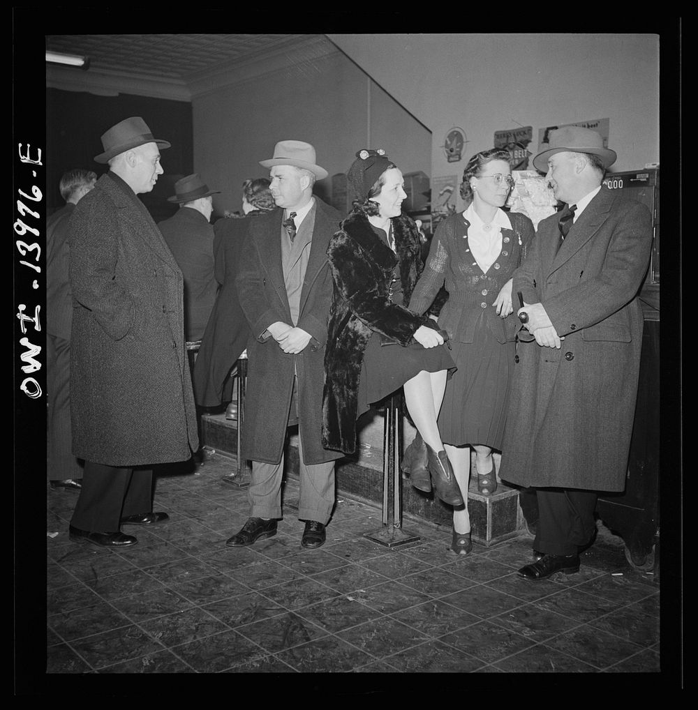 Clinton, Iowa. Rear brakeman Clarence Averill (right) goes over to the bowling alley in the evening with friends. Left to…