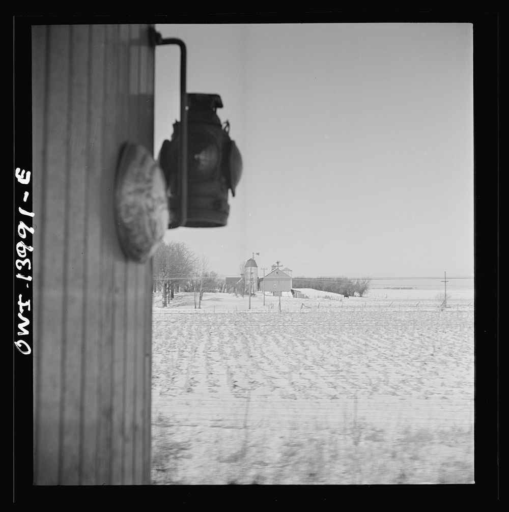 Freight train operations on the Chicago and Northwestern Railroad between Chicago and Clinton, Iowa. Snow covered farms…