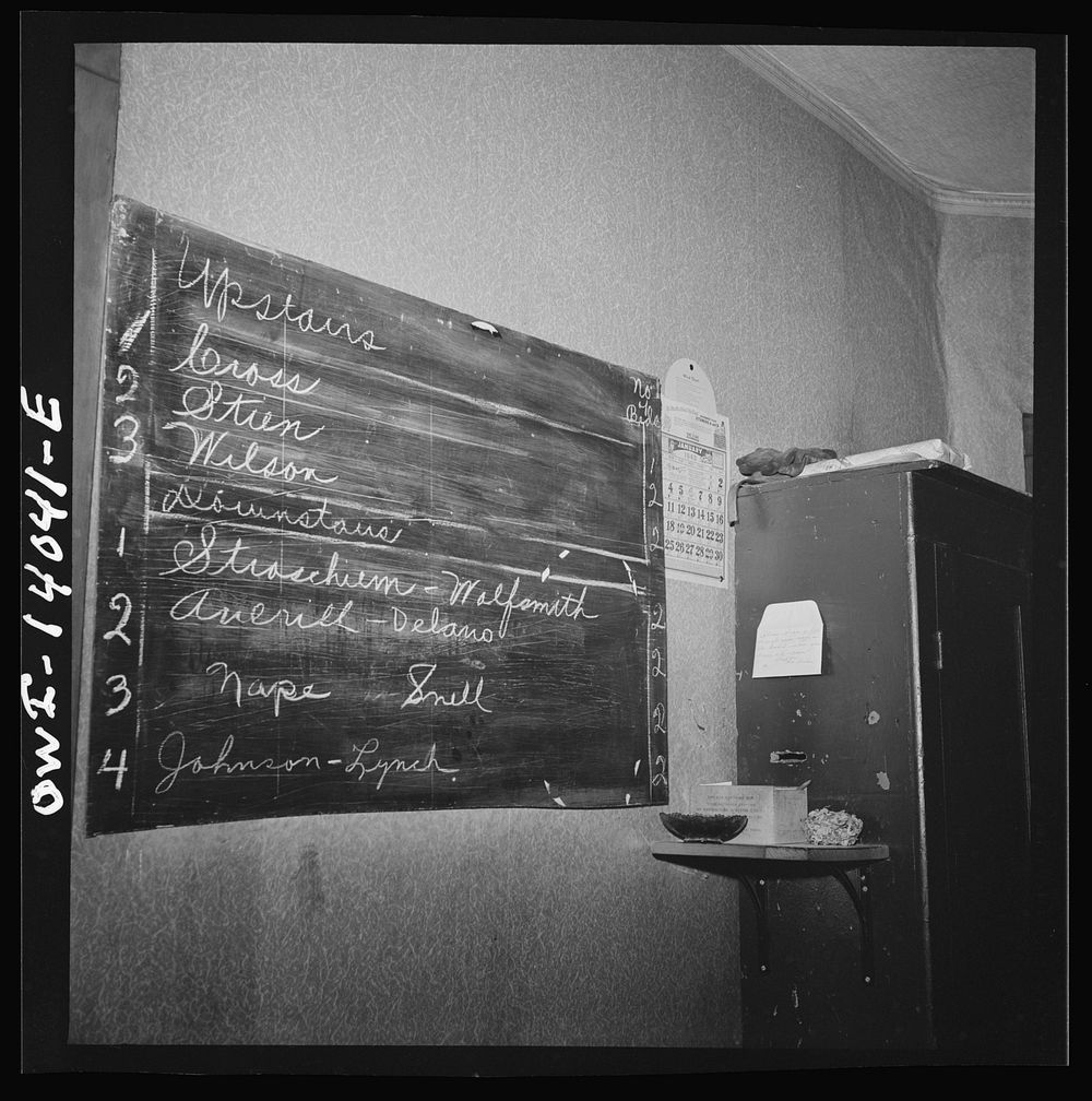 Clinton, Iowa. Blackboard in the Disher rooming house for railroad workers. It lists the names and room numbers of the men.…