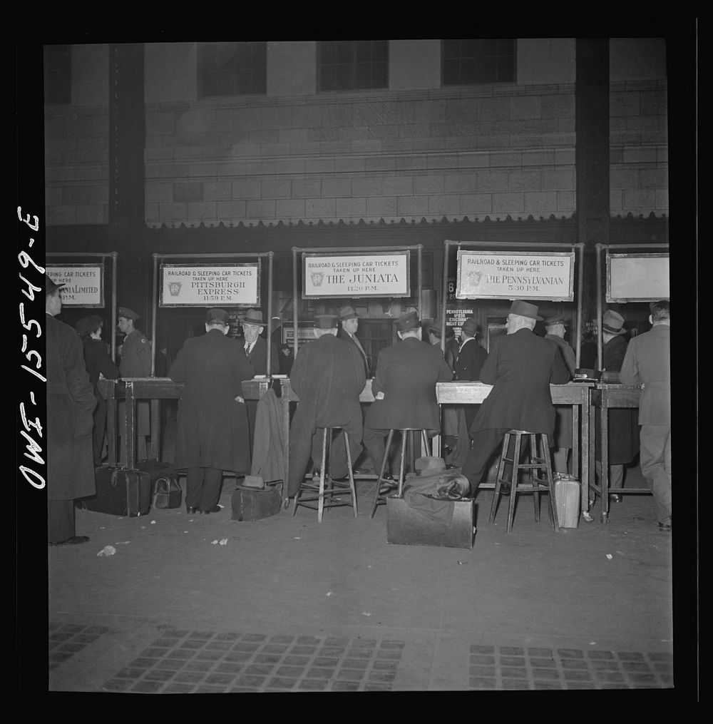 Chicago, Illinois. Checking on Pullman reservations on the Pennsylvania Railroad train at the Union Station. Sourced from…